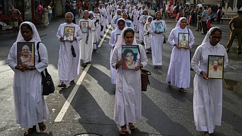Sri Lankan Catholics nuns carry portraits of the victims of the 2019 Easter Sunday attacks during its sixth anniversary commemoration in Colombo, 21 April, 2025