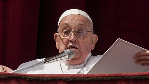 Pope Francis appears on the central lodge of St. Peter's Basilica at the end of the Easter mass. 