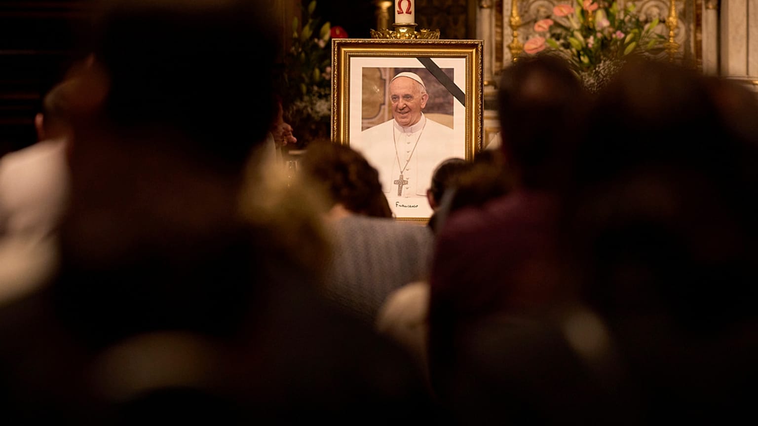 Fedeli assistono a una funzione religiosa in onore di Papa Francesco dopo l'annuncio della sua morte, nella cattedrale di San Giuseppe a Bucarest, Romania, 21 aprile 2025