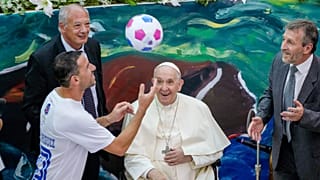 Pope Francis and Scholas Occurrentes President José María del Corral watch Argentine midfielder Maxi Rodríguez juggle a football in Rome on 19 May 2022.