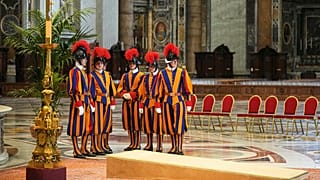 Vatican Swiss Guards wait in St. Peter's Basilica ahead of the arrival of the body of Pope Francis, who will lie in state for three days, at the Vatican, April 23, 2025.