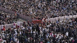 The body of Pope Francis is carried through St Peter's Square to St Peter's Basilica at the Vatican, 23 April, 2025