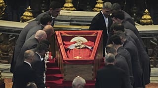 Pallbearers place the body of Pope Francis inside St Peter's Basilica at the Vatican, 23 April, 2025