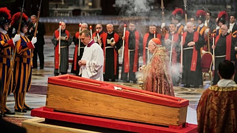 Cardinal Camerlengo Kevin Joseph Farrell, center right, spreads incense around the body of Pope Francis inside St. Peter's Basilica at the Vatican, Wednesday, April 23, 2025.