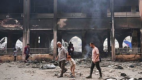 Palestinians inspect the damage after an Israeli army airstrike on Yaffa School, in Gaza City, Wednesday, April 23, 2025. 