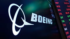 The logo for Boeing appears on a screen above a trading post on the floor of the New York Stock Exchange, July 13, 2021. 