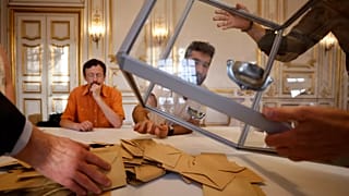 Volunteers empty a ballot box after the first round of the parliamentary election in Strasbourg, 12 June 2022