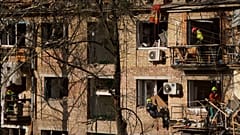 Rescue workers clear the rubble of a house damaged by a Russian strike on a residential neighbourhood in Kyiv, 24 April 2025