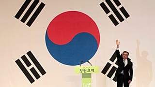 FILE: Moon Jae-in, waves in front of a South Korean flag after he was elected to the presidential candidate at his party convention in Goyang, 16 September 2012