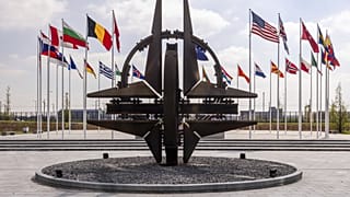 A szövetség tagjainak zászlói lobognak a szélben a védelmi miniszterek ülése előtt a NATO brüsszeli központjában, 2025. április 10-én.