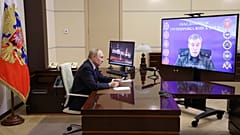 Russian President Vladimir Putin listens to Russian Chief of General Staff Gen. Valery Gerasimov saying that Ukrainian troops have been forced from Kursk, April 26, 2025. 