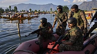 FILE: Paramilitary soldiers board a patrol boat as Indian tourists take boat rides on Dal Lake in Srinagar, Indian controlled Kashmir, Friday, April 25, 2025.