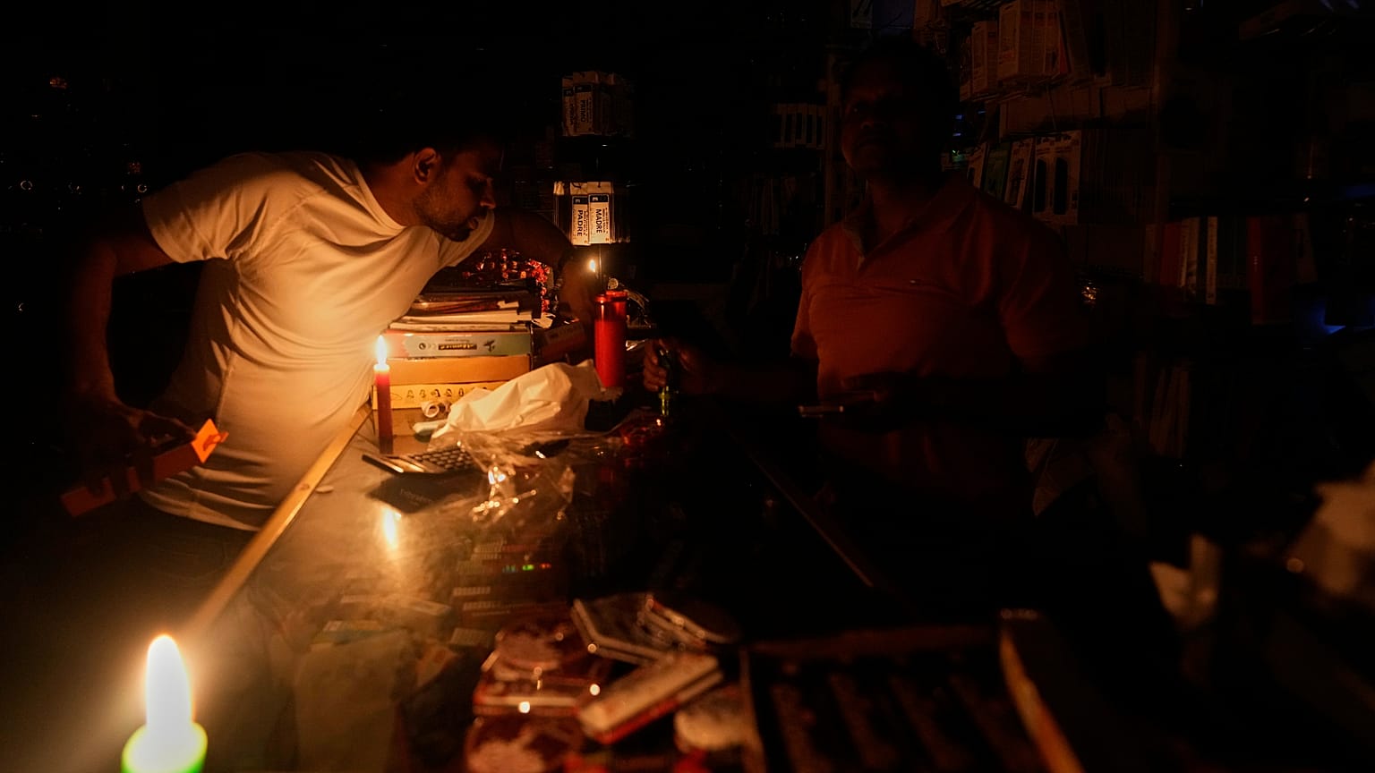 A vendor sits inside his shop during a major power outage in Madrid, 28 April, 2025