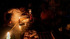 A vendor sits inside his shop during a major power outage in Madrid, 28 April, 2025
