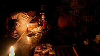 A vendor sits inside his shop during a major power outage in Madrid, 28 April, 2025