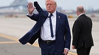 President Donald Trump waves as he arrives at Newark Liberty International Airport