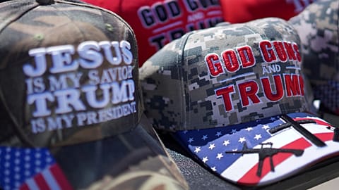 Hats reading, "God, Guns and Trump," and "Jesus is my savior, Trump is my president," are sold at a campaign rally for Donald Trump.