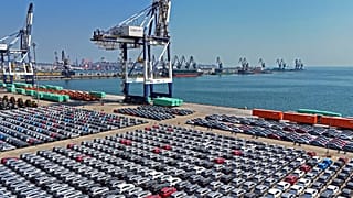 FILE An aerial view of new cars waiting for shipment at a pier for ro-ro ships in Yantai city in eastern China's Shandong province, 30 March 2025