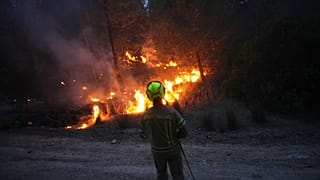 An Israeli firefighter works as forest fire is burning near Jerusalem, 30 April, 2025