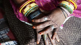 A wristwatch-style health monitor to study how heat affects vulnerable communities is worn by Shantaben Vanzara at her house in Ahmedabad, India.