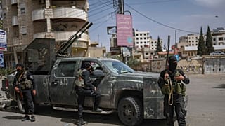 Members of Syria's security forces deploy in the town of Sahnaya, 1 May 2025.