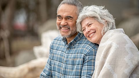 A senior couple sitting happily together. 