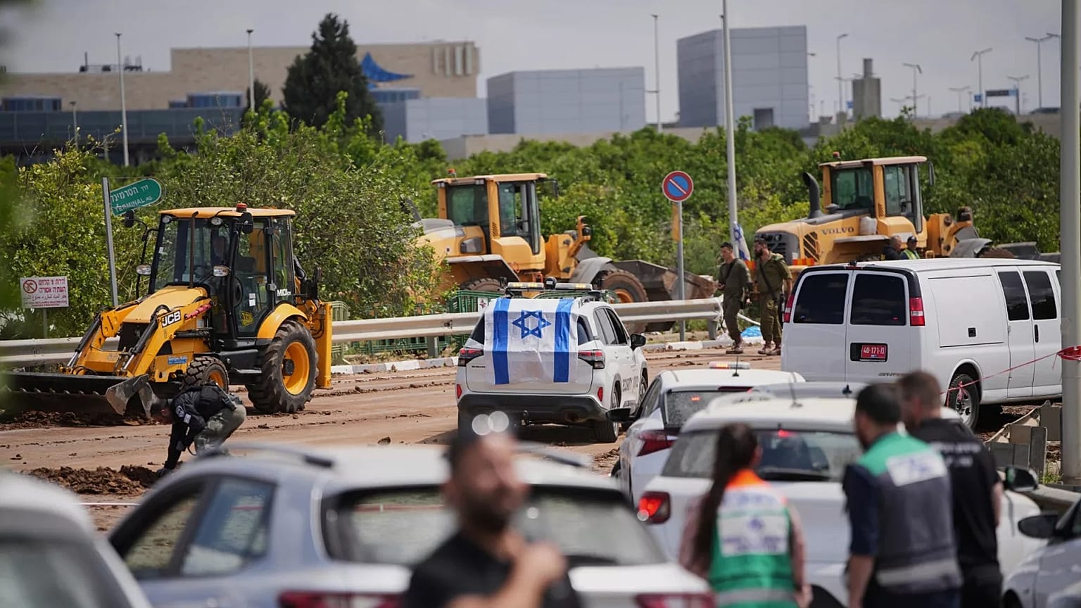 Israeli security forces inspect the site where a missile fired by Yemen's Houthi rebels landed in the area of Ben Gurion International Airport near Tel Aviv, 4 May 2025