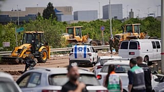 Israeli security forces inspect the site where a missile fired by Yemen's Houthi rebels landed in the area of Ben Gurion International Airport near Tel Aviv, 4 May 2025
