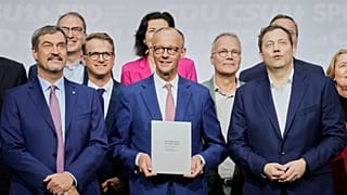 CSU leader Markus Soeder, CDU leader Friedrich Merz and SPD leader Lars Klingbeil stand together after signing the coalition treaty in Berlin, Germany, Monday, May 5, 2025.