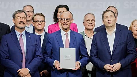 CSU leader Markus Soeder, CDU leader Friedrich Merz and SPD leader Lars Klingbeil stand together after signing the coalition treaty in Berlin, Germany, Monday, May 5, 2025.