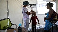 A Doctors without Borders staff measures a child's height at the organizations medical clinic in Putucual, Venezuela, Wednesday, Jan. 10, 2024.