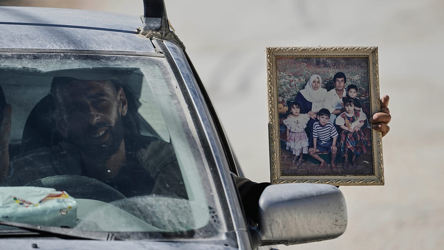 Palestinian resident of the West Bank refugee camp of Nur Shams carries his family photo while evacuates his home ahead of planned demolitions by Israeli security, 06.05.2025