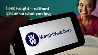 This image shows the logo of WeightWatchers on a mobile phone, and the company's website, in New York, March 7, 2023.