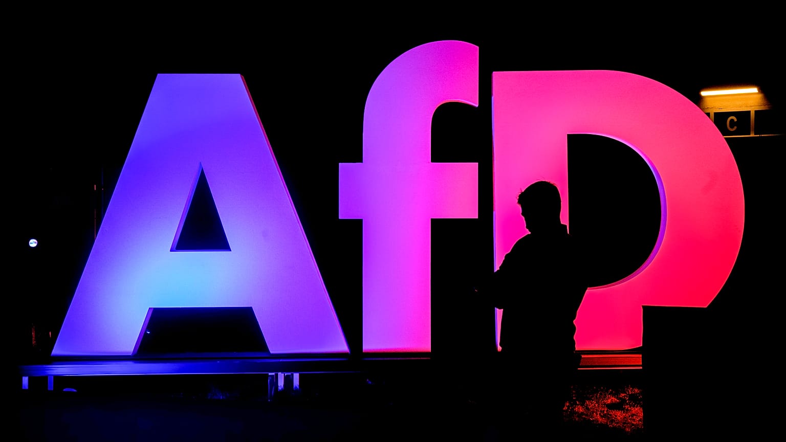 A man stands in front of the logo at the AfD party headquarters in Berlin, 23 February, 2025