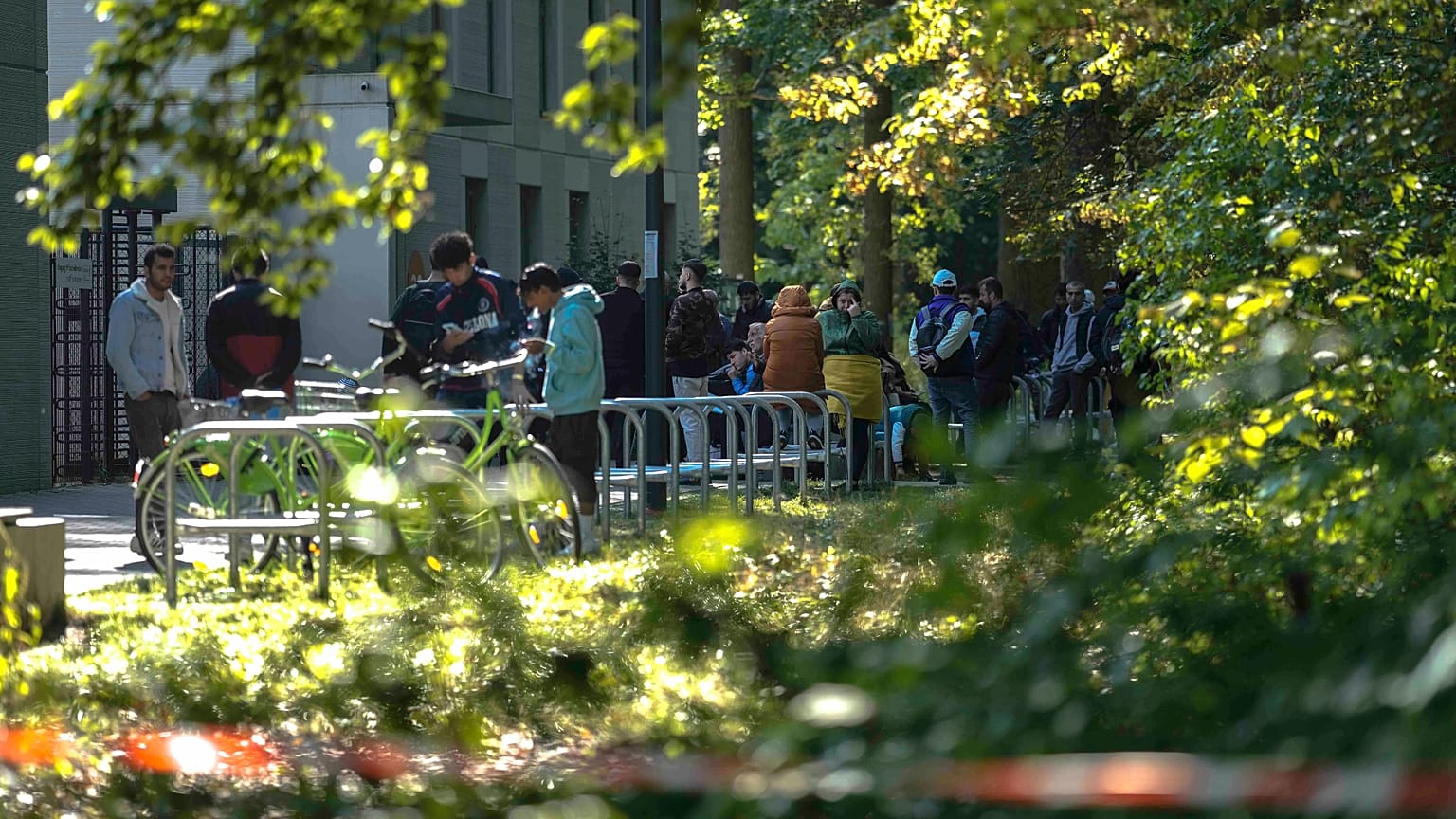 Dozens of people from all over the world line in front of the central registration centre for asylum seekers in Berlin, 25 September, 2023