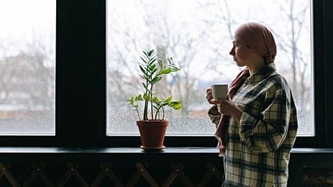 A young woman drinks coffee.