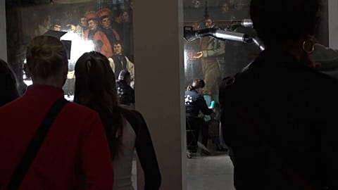 Visitors observing the Courbet restoration process