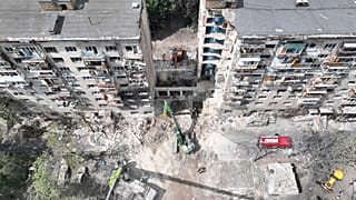 In this aerial photo provided by the Ukrainian Emergency Service, searchers sift through the wreckage on the site of Russia's deadly missile attack, 18 June 2025.