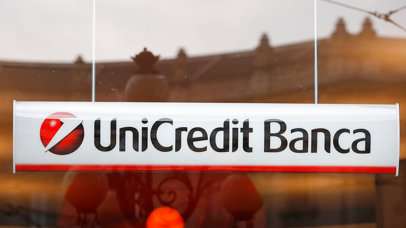The UniCredit bank logo is seen from a window of a bank in downtown Milan, Italy, Wednesday, Oct.1, 2008. 