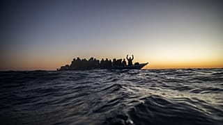 Migrants and refugees wait for assistance on an overcrowded wooden boat in the Mediterranean Sea, 12 February, 2021