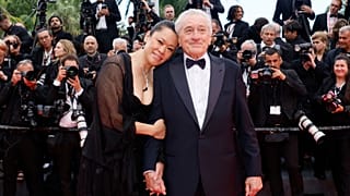 Robert De Niro and Tiffany Chen pose for photographers during the opening ceremony red carpet of the 78th international film festival, Cannes, France, Tuesday, May 13, 2025