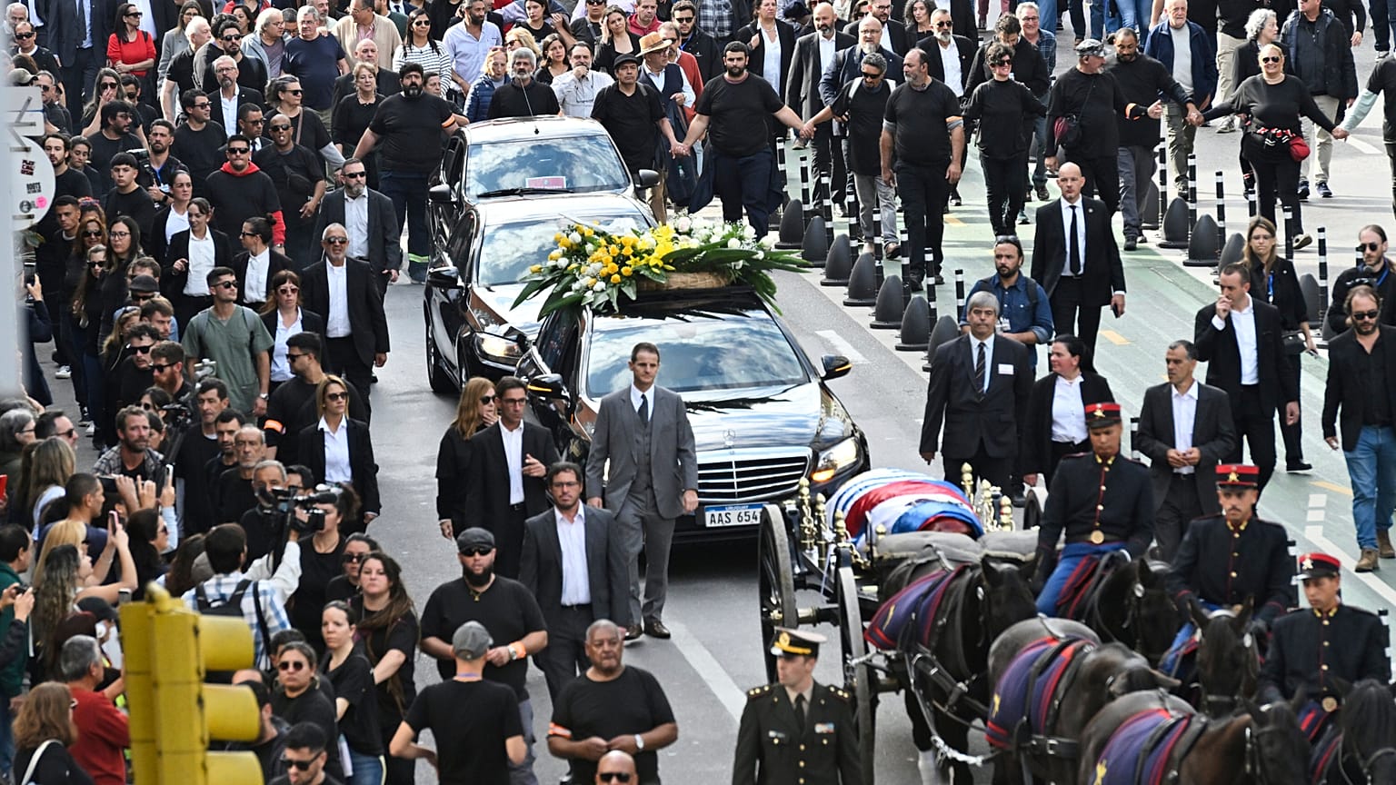 Destekçiler, Uruguay'ın eski Cumhurbaşkanı Jose Mujica'nın cenaze alayı sırasında tabutunun arkasında yürüyorlar, Montevideo, Uruguay, Çarşamba, 14 Mayıs 2025.