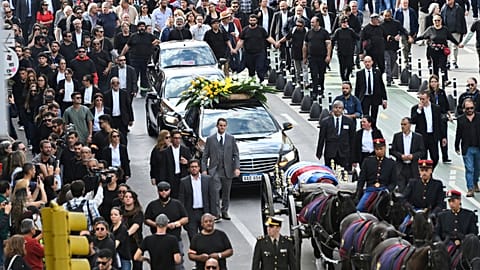 Supporters walk behind the casket of Uruguay's former President Jose Mujica during his funeral procession, in Montevideo, Uruguay, Wednesday, May 14, 2025.