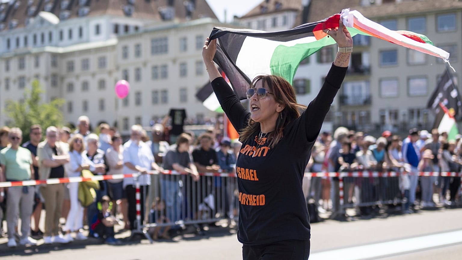متظاهرة ترفع العلم الفلسطيني خلال حفل افتتاح النسخة التاسعة والستين من مسابقة الأغنية الأوروبية (يوروفيجن) في بازل، سويسرا، يوم الأحد، 11 مايو 2025
