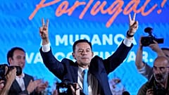 Leader of the center-right Social Democratic Party Luis Montenegro gestures while addressing his supporters following Portugal's general election, in Lisbon.