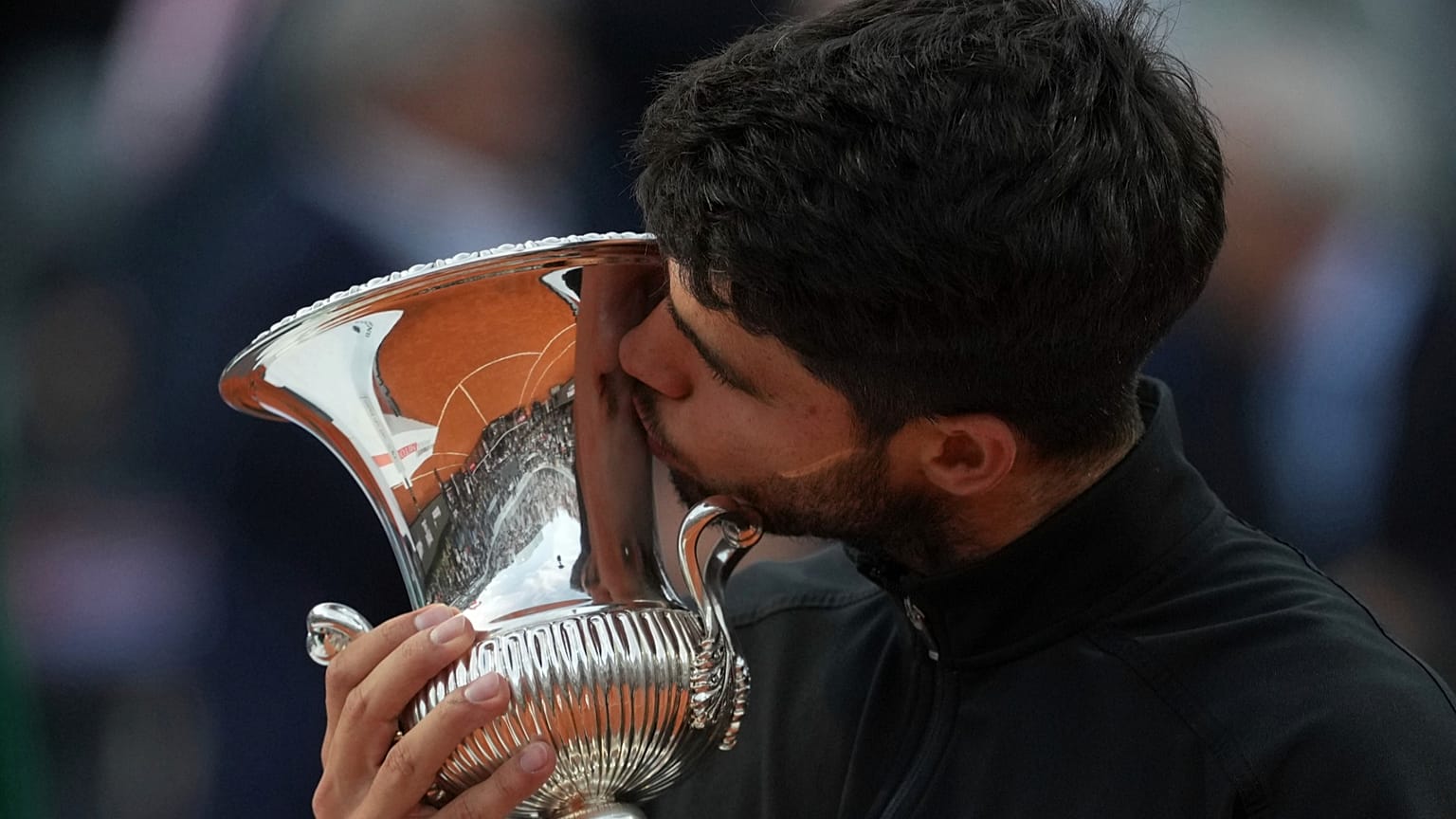 Carlos Alcaraz of Spain kisses the trophy after winning the Italian Open tennis tournament at the Foro Italico in Rome, 18 May 2025