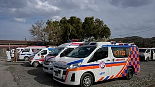 Ambulances park outside a railway station where rescued and injured passenger of a train attacked by insurgents are brought on 12 March, 2025.