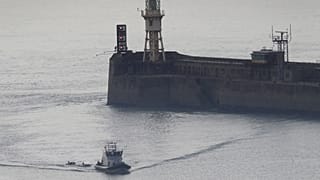 A Border Force vessel brings a group of people thought to be migrants into the port city of Dover, England, on 8 August, 2020.