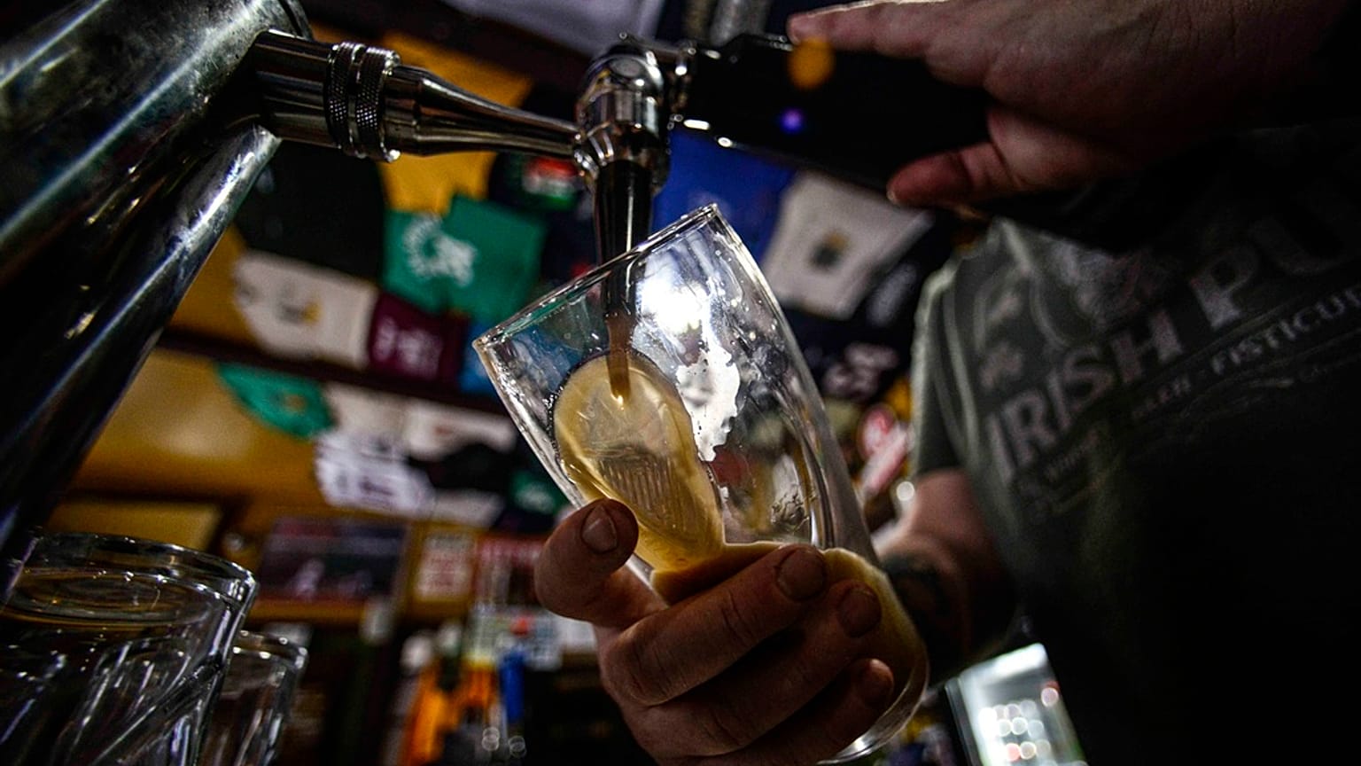 Brian Kerry, co-owner of P.K. Irish Pub in Bellows Falls, Vt., pours a pint of Guinness beer on St. Patrick's Day on Friday, March 17, 2023. 