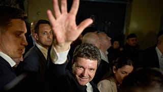 Presidential candidate Nicusor Dan waves to supporters after winning the second round of the country's presidential election redo in Bucharest, 19 May 2025